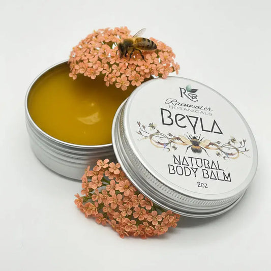 Open tin of Rainwater Botanicals Beyla Natural Body Balm on a light gray background