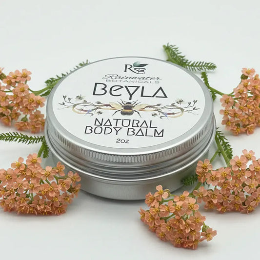 Beyla natural body balm tin with 'Rainwater Botanicals' branding on a light gray background