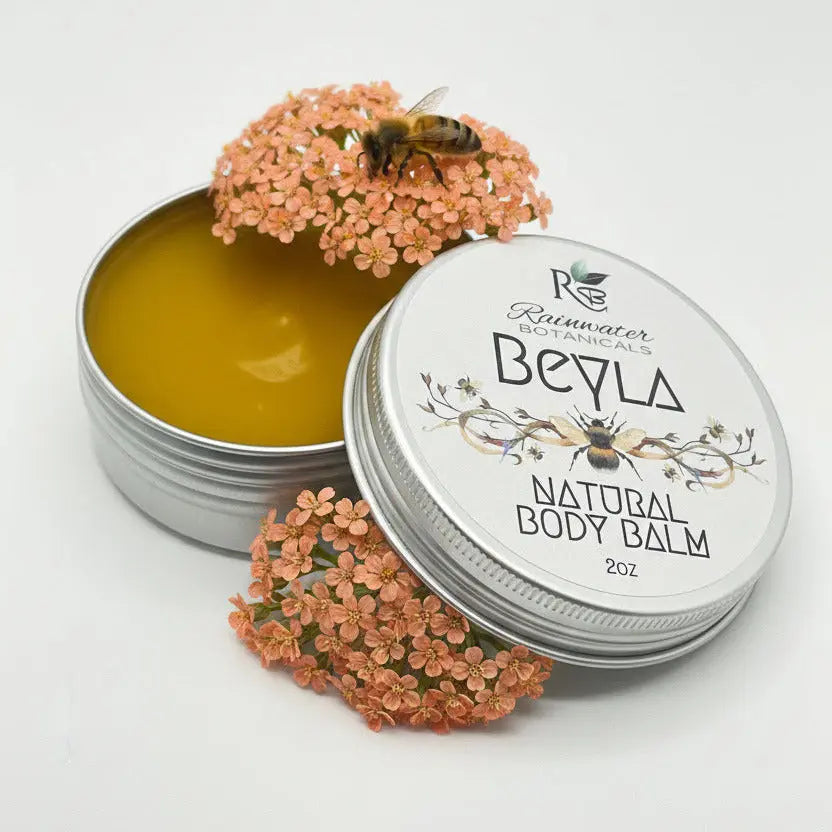 Open tin of Rainwater Botanicals Beyla Natural Body Balm on a light gray background