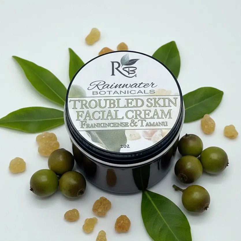 Jar of Rainwater Botanicals Troubled Skin Facial Cream on a light gray background