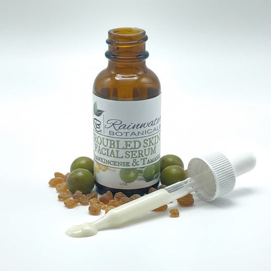 Bottle of Rainwater Botanicals Doubled Skin Facial Serum with dropper on a white background