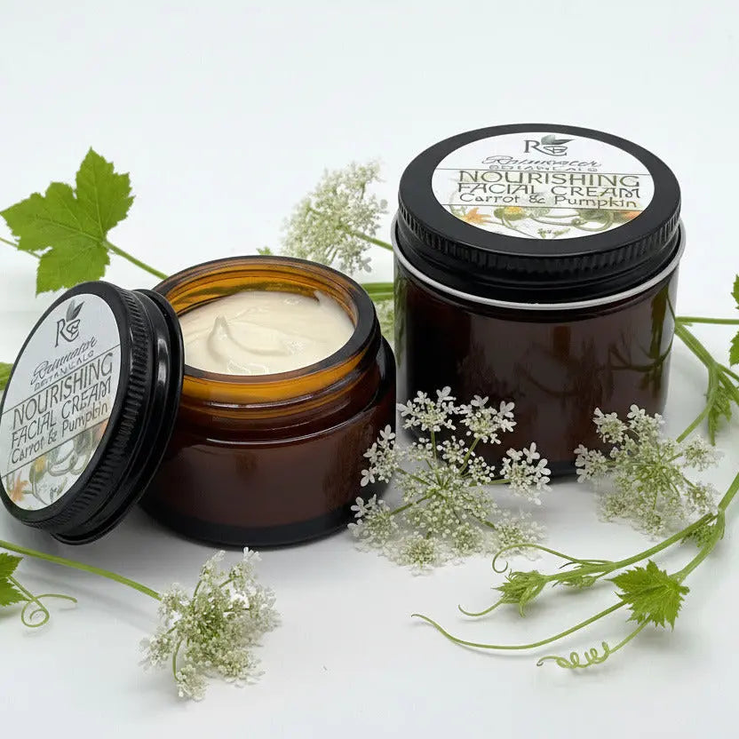 Two jars of nourishing facial cream with black lids on a white background