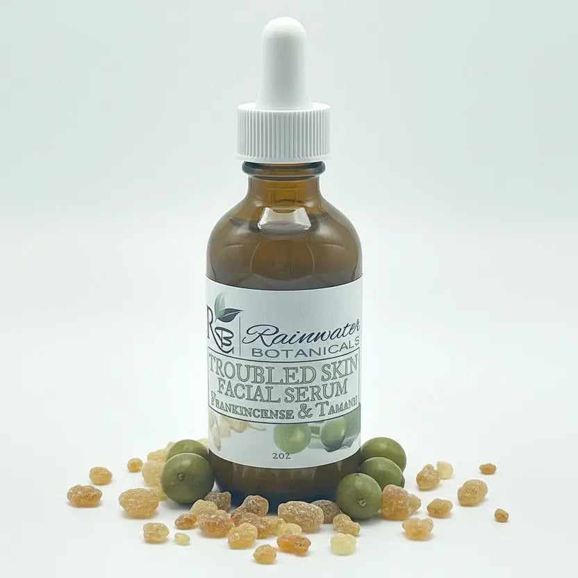 Bottle of Rainwater Botanicals Troubled Skin Facial Serum with dropper on a white background