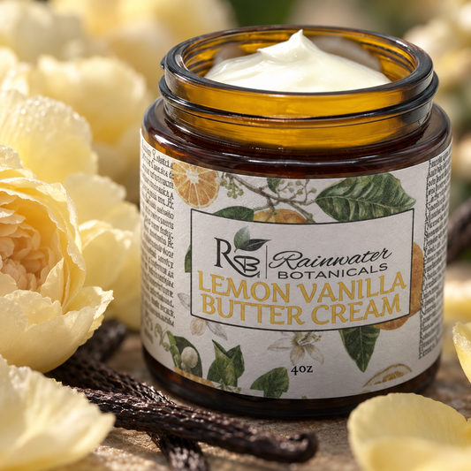 An amber glass jar of Rainwater Botanicals Lemon Vanilla Butter Cream with white cream visible inside, surrounded by yellow flowers and vanilla beans on a rustic surface.